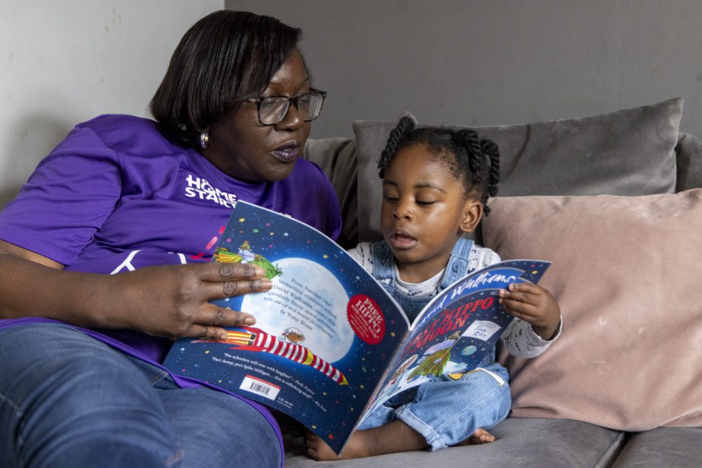 volunteer reading with little boy
